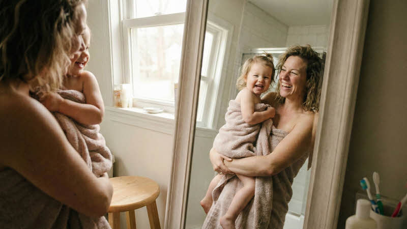 Self-Compassion: Mother and daughter looking into mirror
